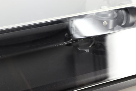 Close up of a used Revolver Rebel Turntable / AT95E Cartridge in a black finish showing some damage on the lid