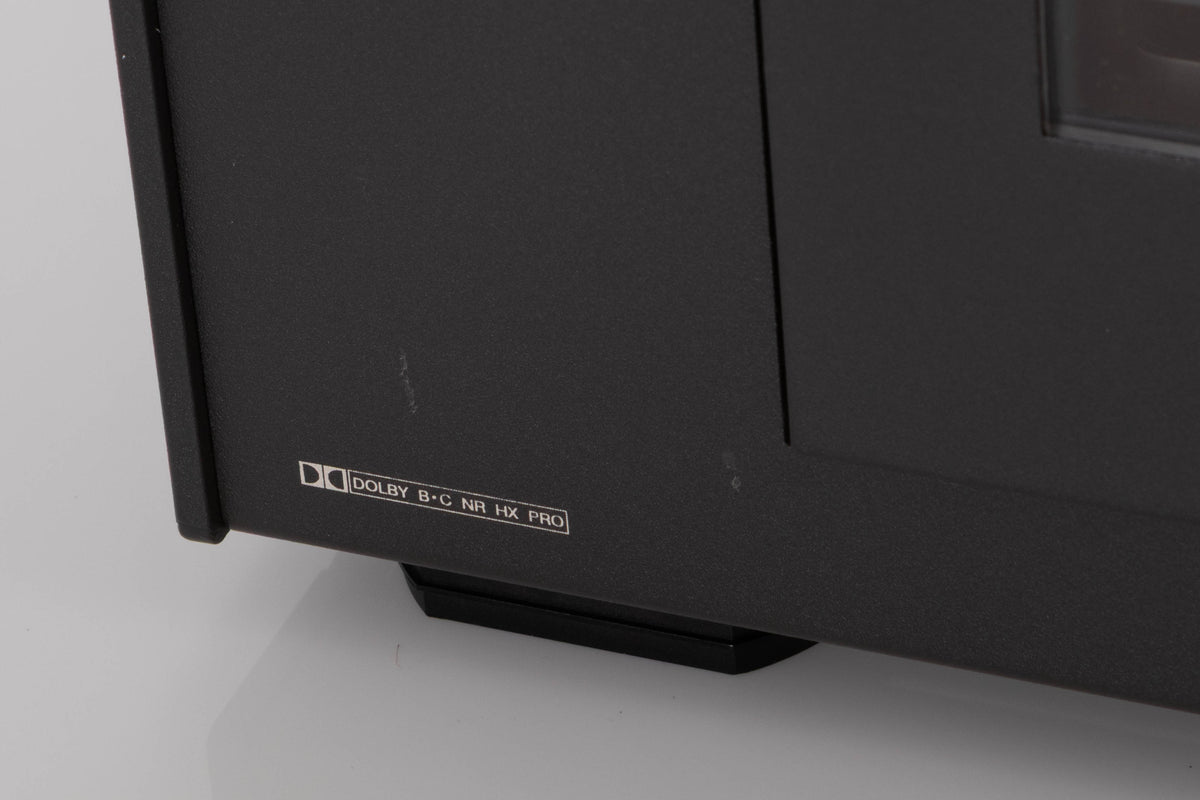 Close up of a used Revox C115 Cassette Tape Deck in a Black finish showing few light scratches on fascia