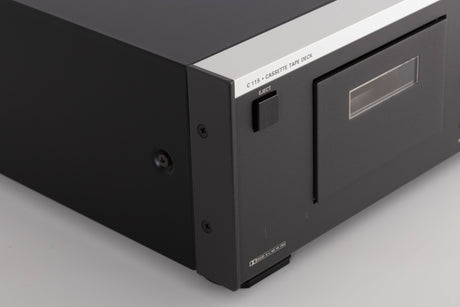 Front left corner of a used Revox C115 Cassette Tape Deck in a Black finish