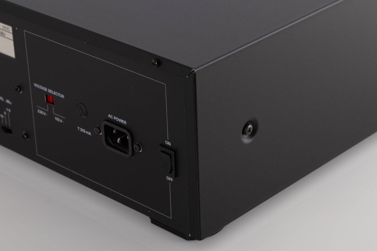 Rear left corner of a used Revox C115 Cassette Tape Deck in a Black finish