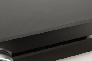 Close up view of a used Roksan Attessa Integrated Amplifier in Black finish showing a small chip on the front edge