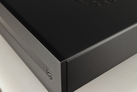 Close up of a used Roksan Attessa Integrated Amplifier in a black finish showing light scratch on right side