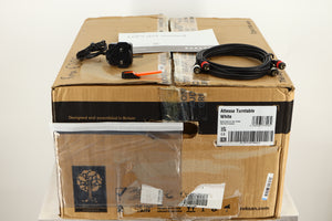 Box of a used Roksan Attessa Turntable in White finish showing Mains Cable, Manual, Interconnects, and Tracking Force Gauge