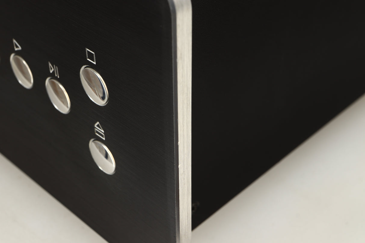 Close up view of a used Roksan BLAK CD Player in Charcoal finish showing some dents on the front right corner 