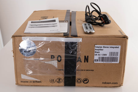 Box of a used Roksan Caspian M2 Integrated Amplifier in Black with mains cable, remote, and manual