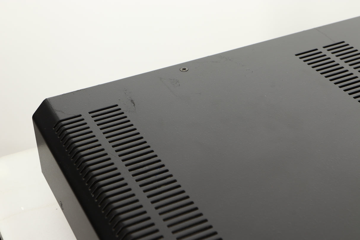 Close up view of a used Roksan Caspian M Series-1 Dual Mono Pre Amplifier in Silver finish showing scratching on the back corner 