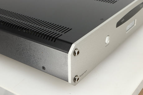 Front left corner of a used Roksan Caspian MSeries-1 Power Amplifier in a silver finish