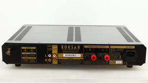 Rear view of a used Roksan Caspian MSeries-1 Power Amplifier in a silver finish showing Phono Inputs, Phono Outputs and Mains Cable