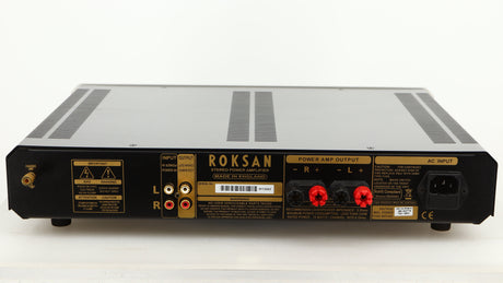 Rear view of a used Roksan Caspian MSeries-1 Power Amplifier in a silver finish showing Phono Inputs, Phono Outputs and Mains Cable