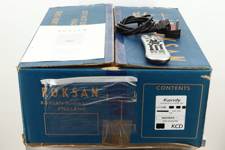 Box of a used Roksan Kandy KC1 MkIII CD Player in Black finish showing mains cable, manual, and remote 