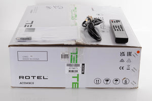 Box of a used Rotel A11MKII Integrated Amplifier with mains cable, manual, and remote
