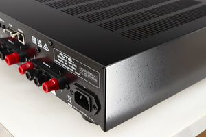 Rear left corner of a used Rotel A14 MKII Integrated Amplifier in a black finish