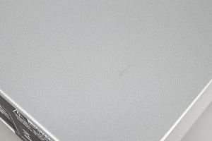 Close up of a used Rotel CD11 Tribute CD Player in a silver finish showing a scratch on top