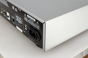 Rear left corner of a used Rotel CD11 Tribute CD Player in a silver finish