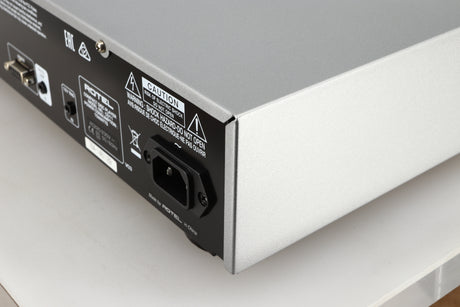 Rear left corner of a used Rotel CD11 Tribute CD Player in a silver finish