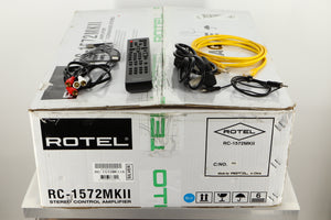 Box of a used Rotel RC-1572 MKII Pre Amplifier in Silver finish with mains cable, remote, ehternet cable, USB cable, RCA cables, and a 3.5mm Cable 