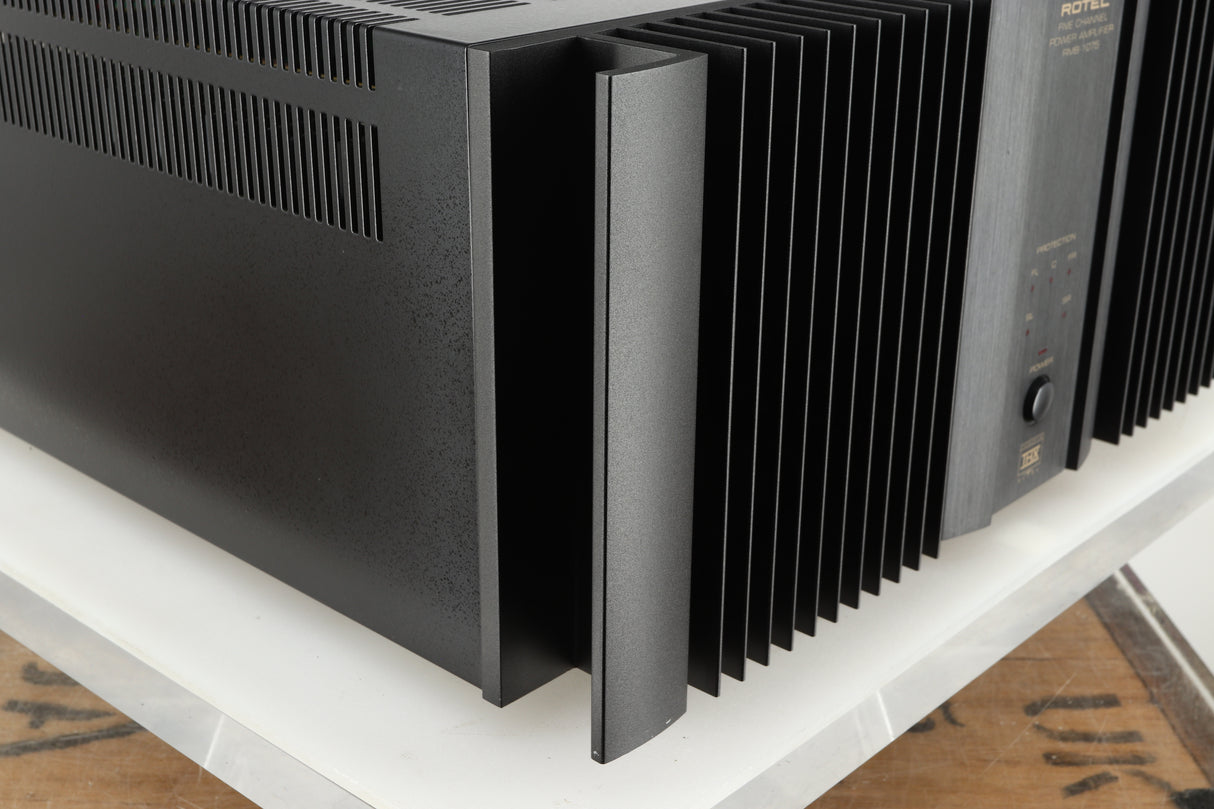 Front left corner of a used Rotel RMB1075 Power Amplifier in a black finish 
