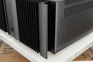 Front right corner of a used Rotel RMB1075 Power Amplifier in a black finish 