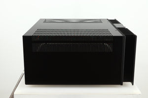 Left side view of a used Rotel RMB1075 Power Amplifier in a black finish 