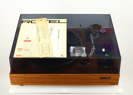 Top of a used Rotel RP-3000 Turntable W/ SME 3009 Series II Improved Tonearm showing Manual, Mounting Template and Cartridge Alignment Protractor, 2x Allen Keys and Brush