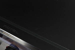 Close up of a used Rotel RSP-1066 Pre Amplifier / Processor in a black finish showing some marks and scratches