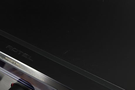 Close up of a used Rotel RSP-1066 Pre Amplifier / Processor in a black finish showing some marks and scratches