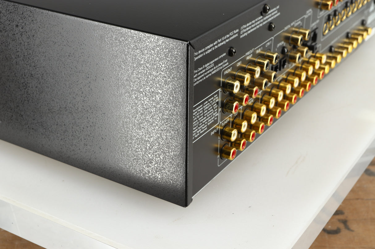 Rear right corner of a used Rotel RSP-1066 Pre Amplifier / Processor in a black finish