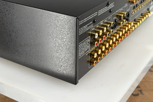 Rear right corner of a used Rotel RSP-1066 Pre Amplifier / Processor in a black finish
