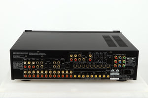 Rear view of a used Rotel RSP-1066 Pre Amplifier / Processor in a black finish showing Phono Outputs and Inputs, Optical Outputs and Mains Input 