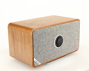 Front left corner of a used Ruark MRX Wireless Speaker in a walnut finish