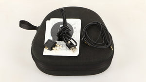 Case for used Sennheiser Momentum 4 Wireless Headphones in a black finish showing Manual, USB Cable, Adaptor and AUX Cable