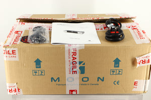 Box of a used Sim Audio Moon 330A Power Amplifier in Black finish with mains cable, manual, and 3.5mm cable 