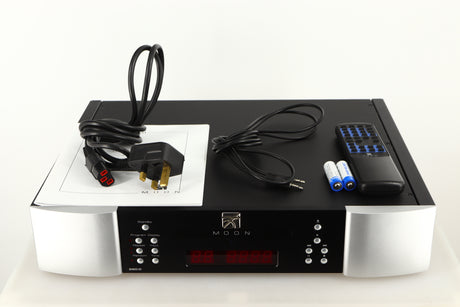 Top of a used Simaudio Moon 260D CD Player in a black / silver finish showing Mains Cable, AUX Cable, Manual, Batteries and Remote