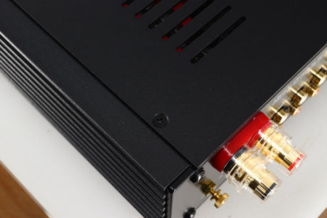 Close up of a used Simaudio Moon 340i D3PX Integrated Amplifier in a black finish showing some light scratches