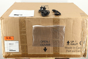 Box of a used Simaudio Moon 860A V2 Power Amplifier in black finish showing manual, mains cable, and a 3.5mm cable
