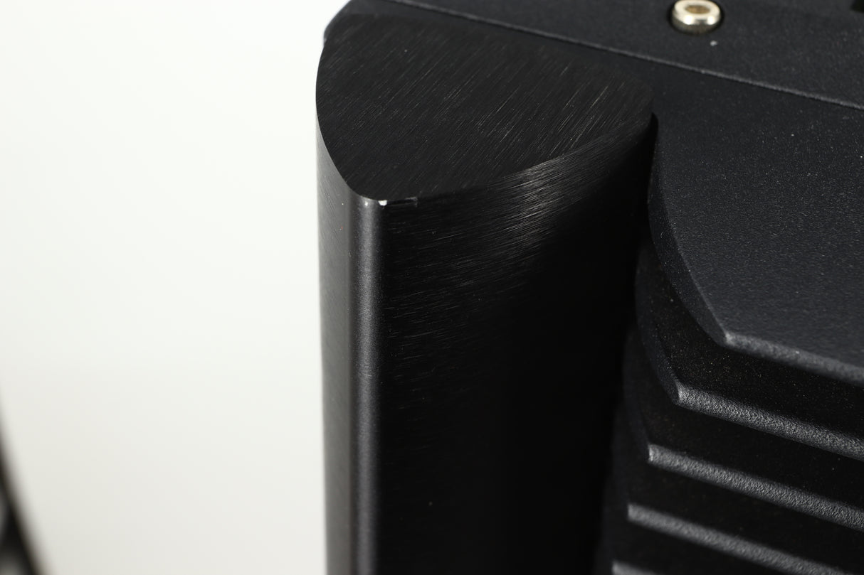 Close up view of a used Simaudio Moon 860A V2 Power Amplifier in black finish showing and small scratch on the top edge of the back of the front right corner 