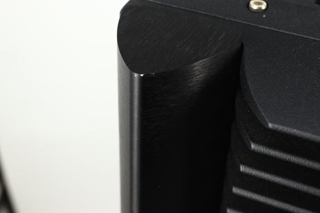 Close up view of a used Simaudio Moon 860A V2 Power Amplifier in black finish showing and small scratch on the top edge of the back of the front right corner 