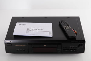 Top of a used Sony CDP-XE330 CD Player in a Black finish showing Manual, Remote and Batteries