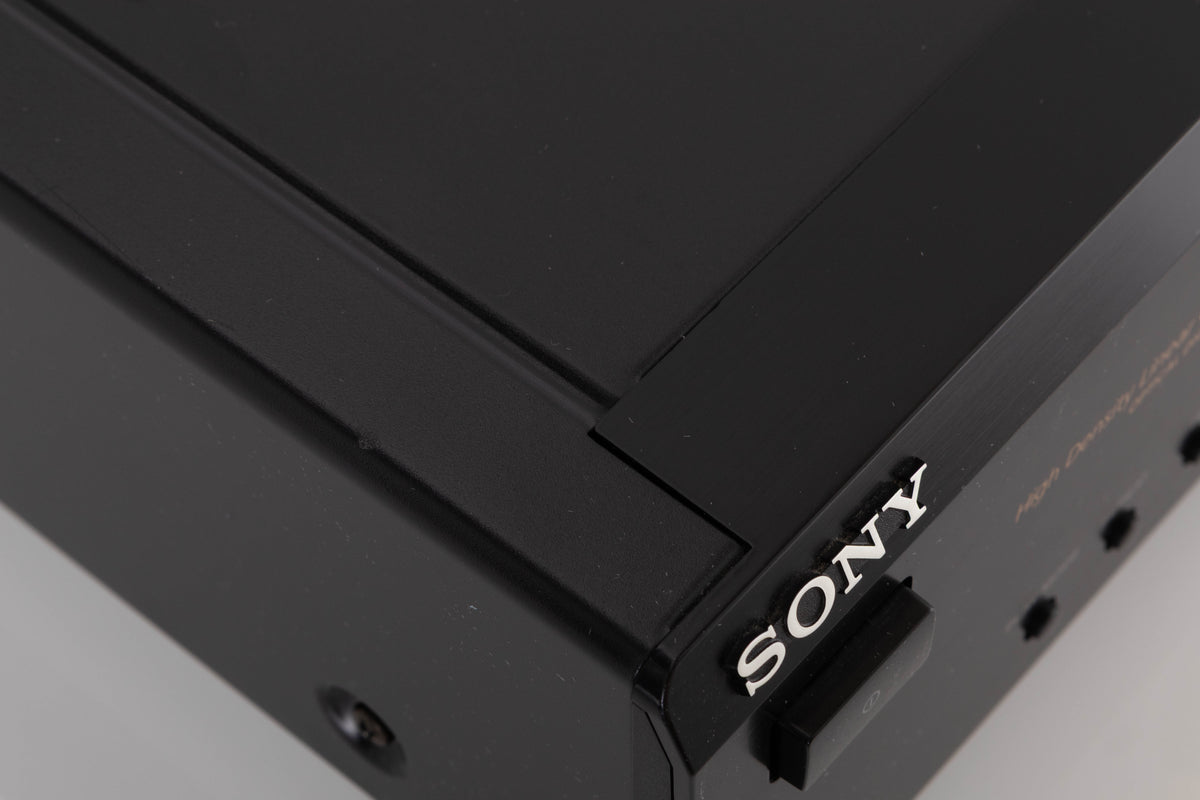 Close up of a used Sony CDP-XE330 CD Player in a Black finish showing scratches on top