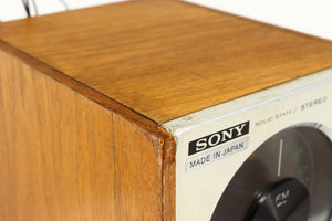 Close up of a used Sony ST-88 Tuner in an oak finish showing some damage on front left corner