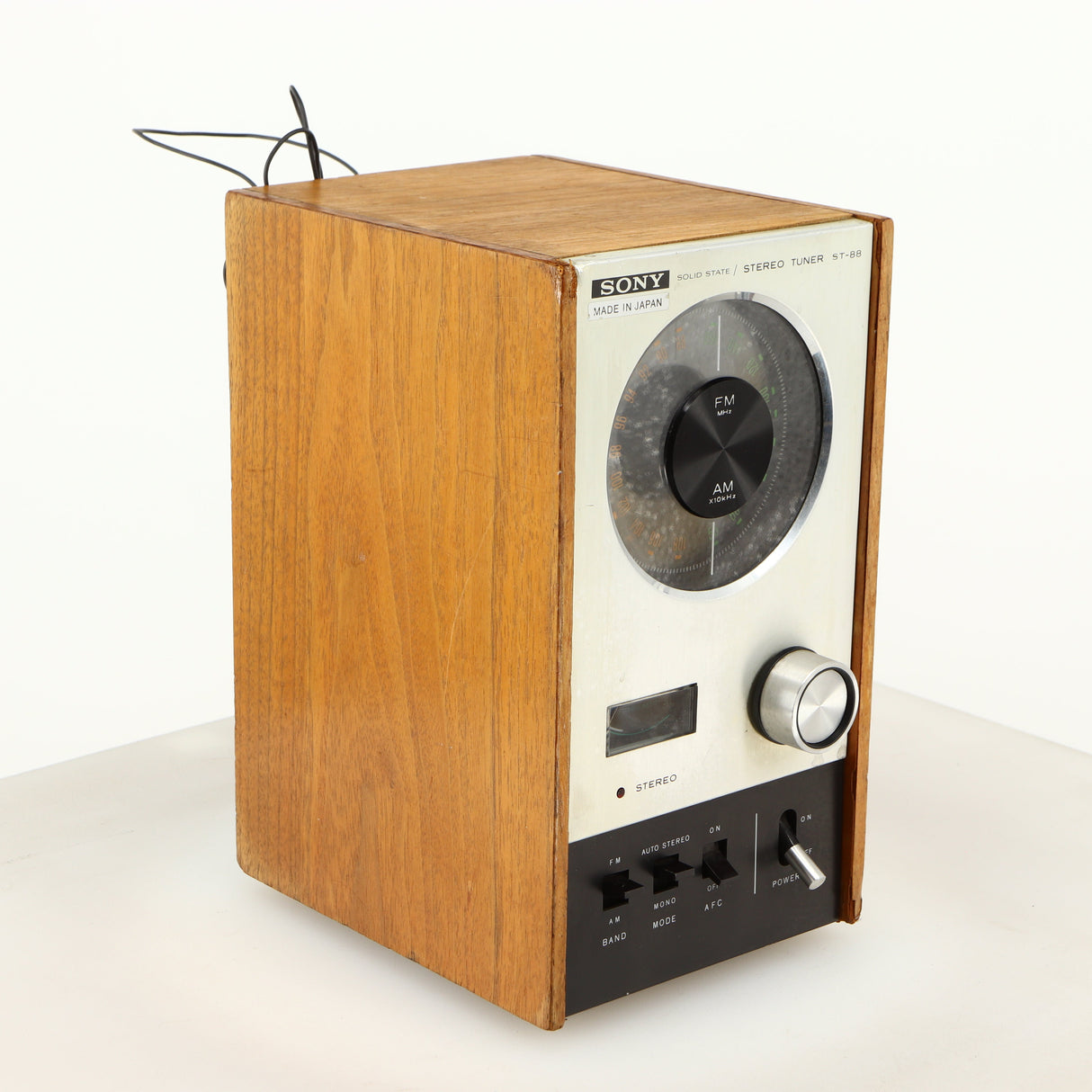 Front left corner of a used Sony ST-88 Tuner in an oak finish 