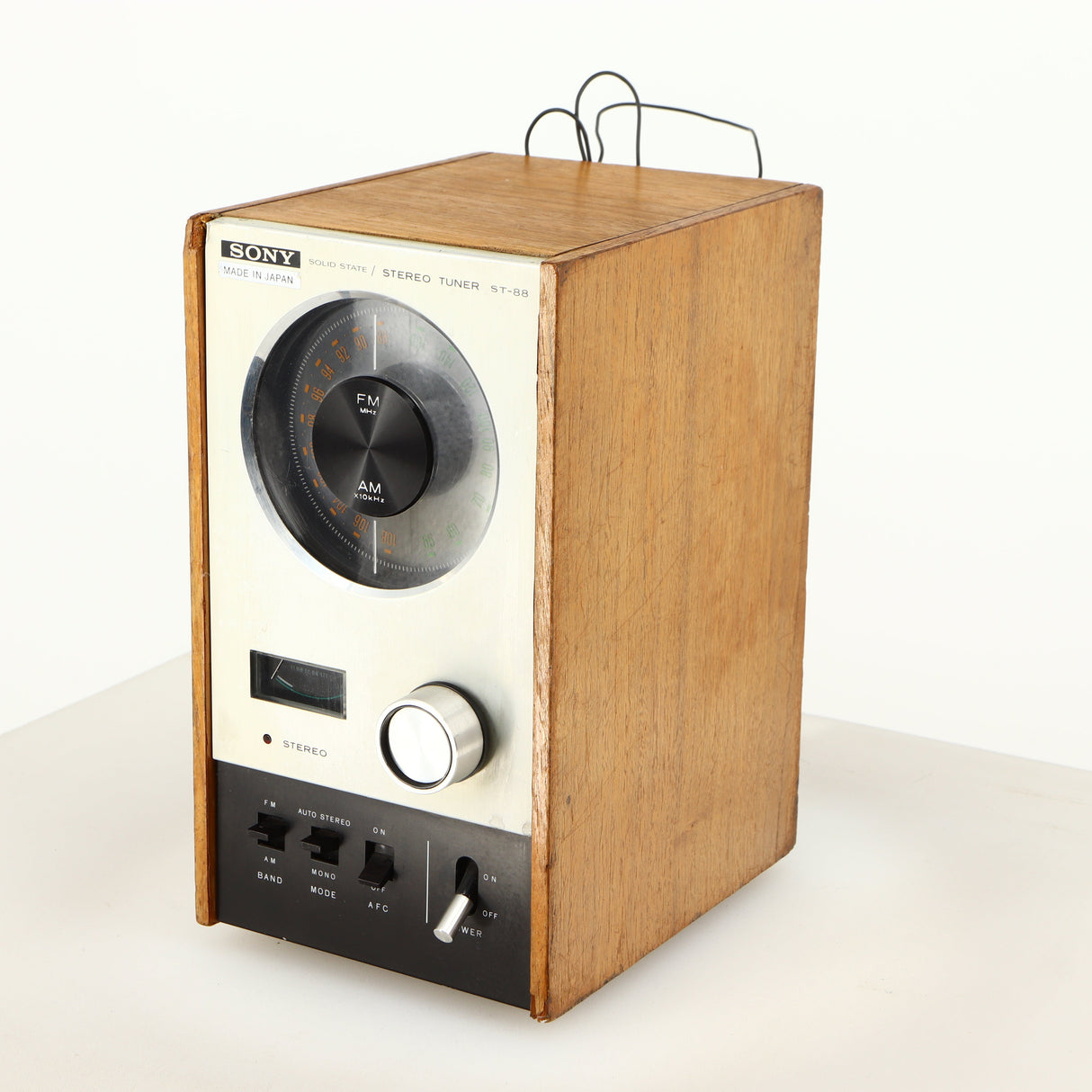 Front right corner of a used Sony ST-88 Tuner in an oak finish 