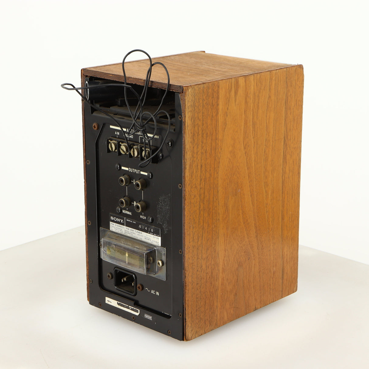 Rear left corner of a used Sony ST-88 Tuner in an oak finish 