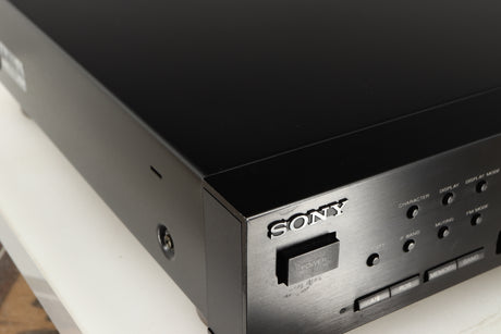 Close up of a used Sony ST-S570ES FM/AM Tuner in a black finish showing few marks on fascia