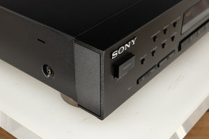 Front left corner of a used Sony ST-S570ES FM/AM Tuner in a black finish