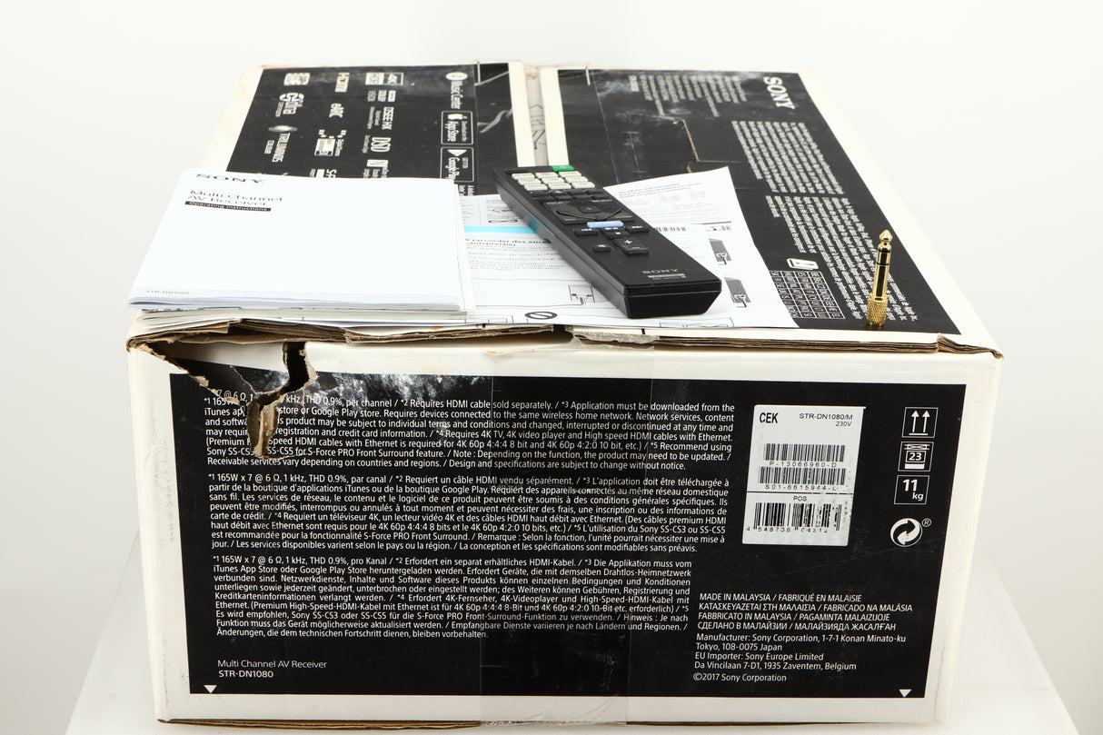 Box for a used Sony STR-DN1080 AV Receiver in a black finish showing Adaptor, Remote and Manual
