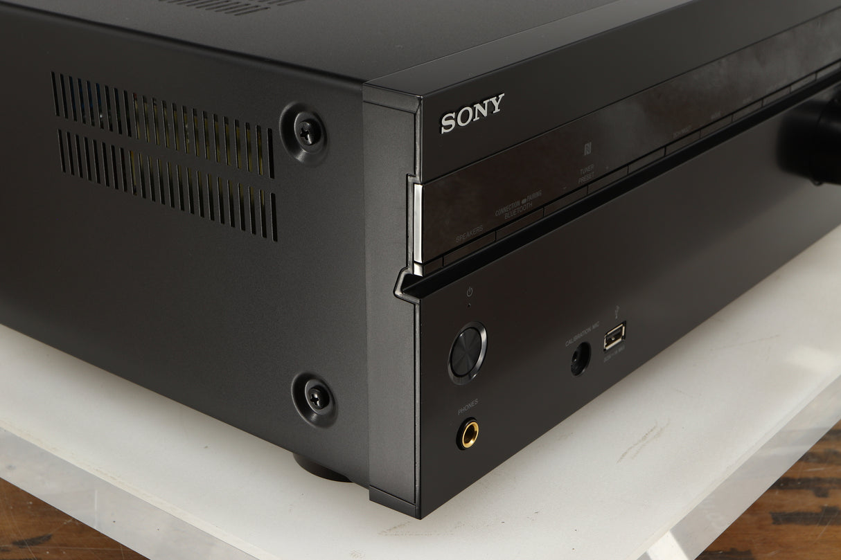 Front left corner of a used Sony STR-DN1080 AV Receiver in a black finish