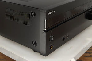 Front left corner of a used Sony STR-DN1080 AV Receiver in a black finish