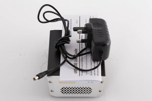 Top of a used SOtM SMS-200 Network Player showing PSU and Manual