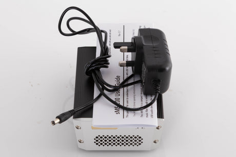 Top of a used SOtM SMS-200 Network Player showing PSU and Manual